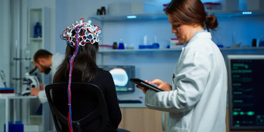 back view woman patient wearing performant eeg headset sitting chair neurological research laboratory