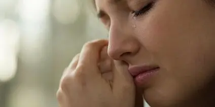 close-up of a young woman with problems crying