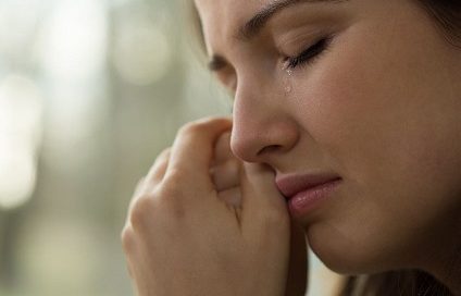 Woman crying and exploring how to treat her depression without medication.