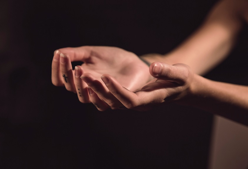 Woman's hands, reflecting on trauma being stored in the body.