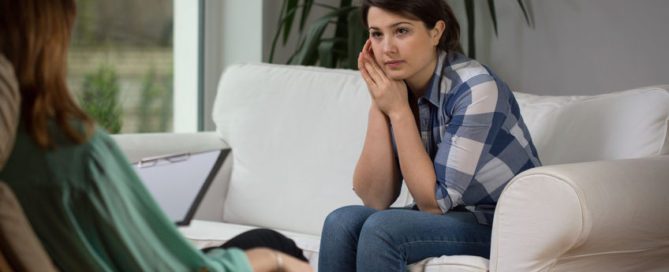 Woman talking to her therapist about what to do when trauma resurfaces.