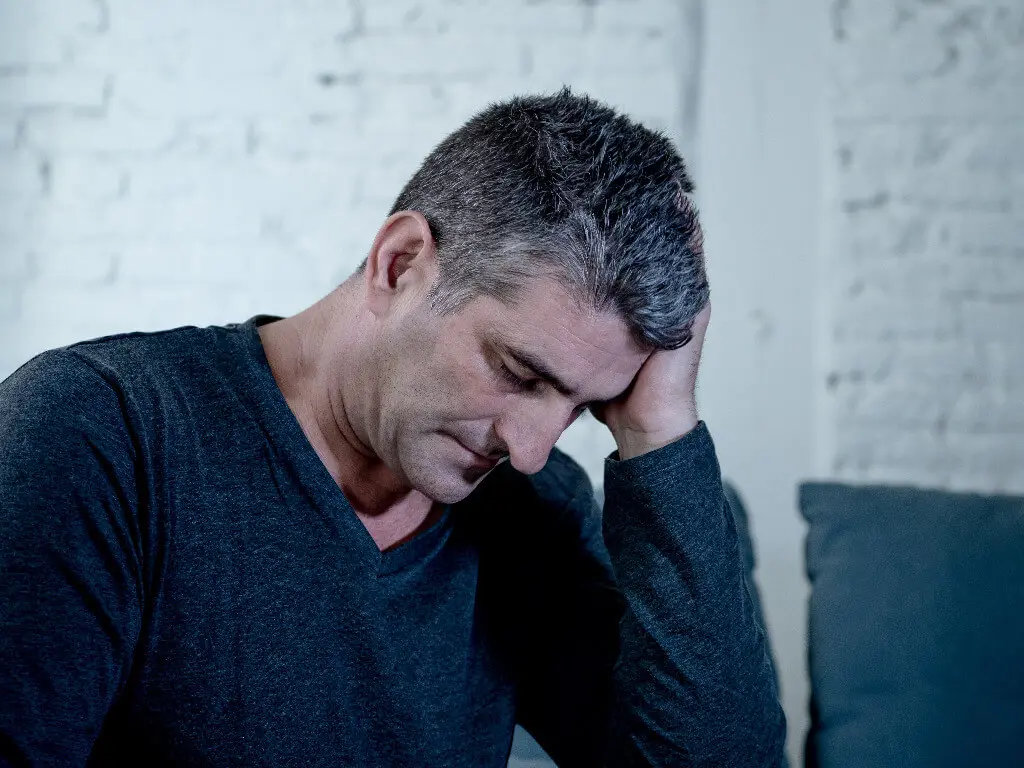 A sad man thinking about neurofeedback for depression