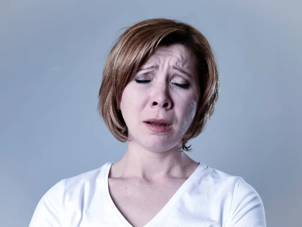 A woman feeling frustrated because of blame shifting by an emotionally immature partner